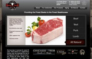 Meats By Linz website. A screenshot of a web page for a wholesale meat company. The design is dark black and grey with a red and white logo in the upper left, a large picture of a New York Strip steak below that and some links and copy in grey, steel-finish and white text below