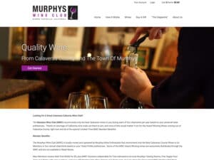 Murphys Wine Club website. A screenshot of a website for a wine club that shows a plain white background, logo and emblem in black and purple in the upper-left and below that a main masthead image of a server opening a wine bottle with some wine glasses in the foreground in a rustic bar setting