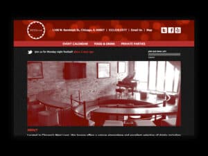 Red Kiva website. A screenshot of a website for a modern piano bar. A red navigation bar with a circular logo emblem with the words "Red Kiva" is in the upper-left, some links are seen to the right and below that a large, sepia-tone image of a modern jazz bar interior with a brick wall, small lounge stage and a grand piano situated on the stage